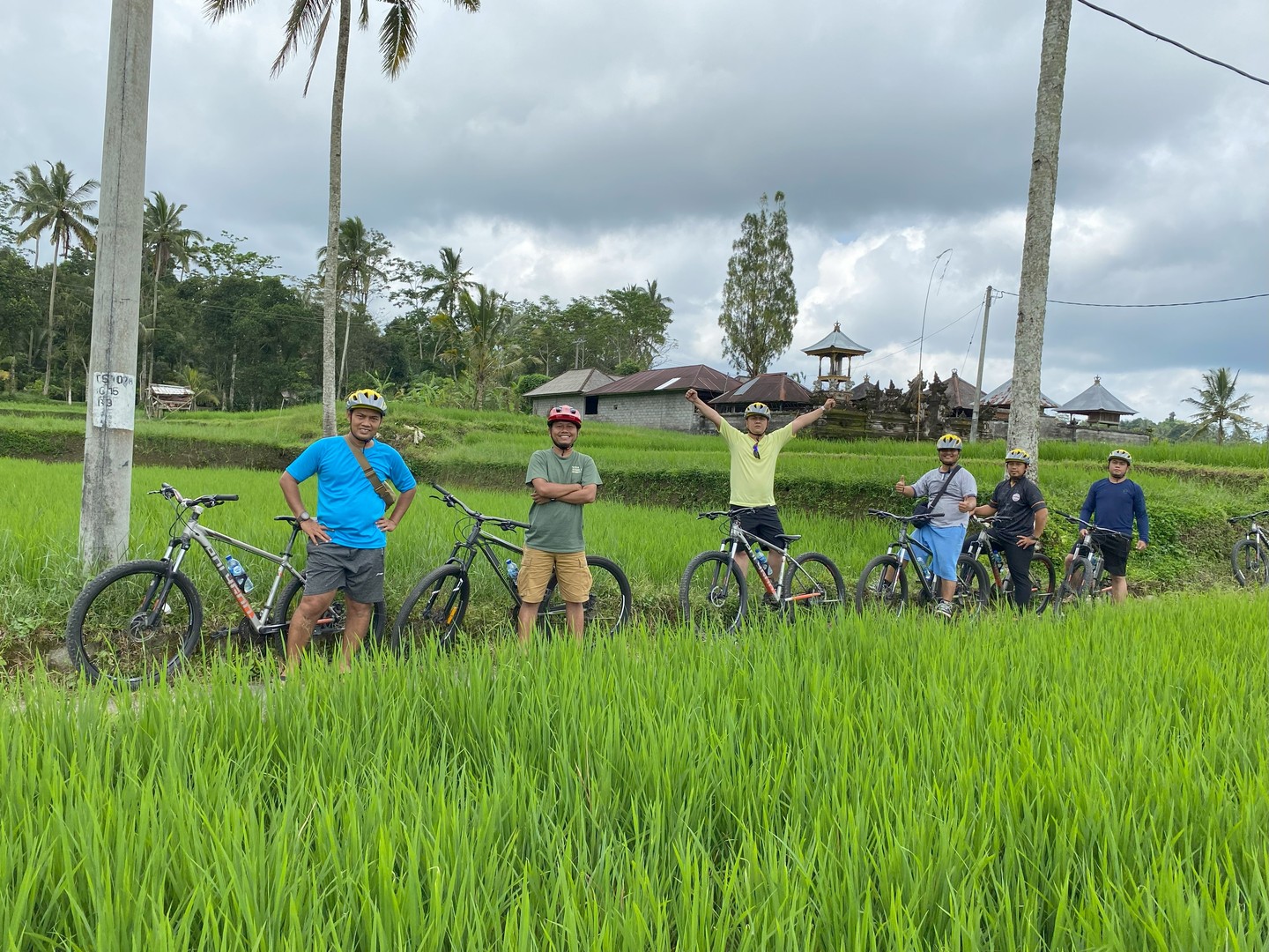 Group of cyclists posing at Bali rice terrace